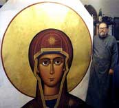 Fr. Luke with wall size head of Theotokos